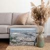 Tableau photo de Paris vu du ciel avec le Parc des Princes et la Tour Eiffel au format 40 x 60 cm posé sur un tapis dans un salon moderne