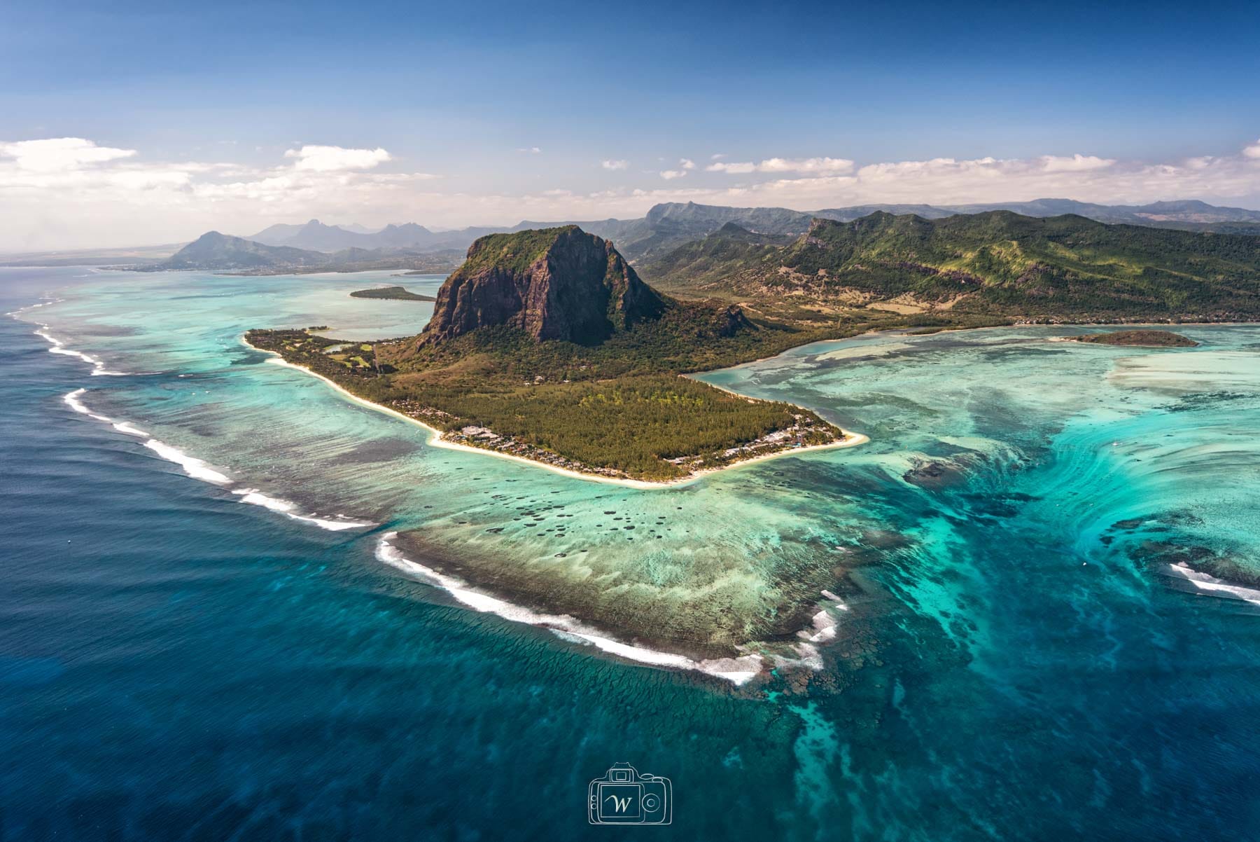Vue aérienne spectaculaire de la péninsule du Morne Brabant à l'île Maurice, bordée par la barrière de corail, un lagon turquoise et l'illusion d'optique de la cascade sous-marine.